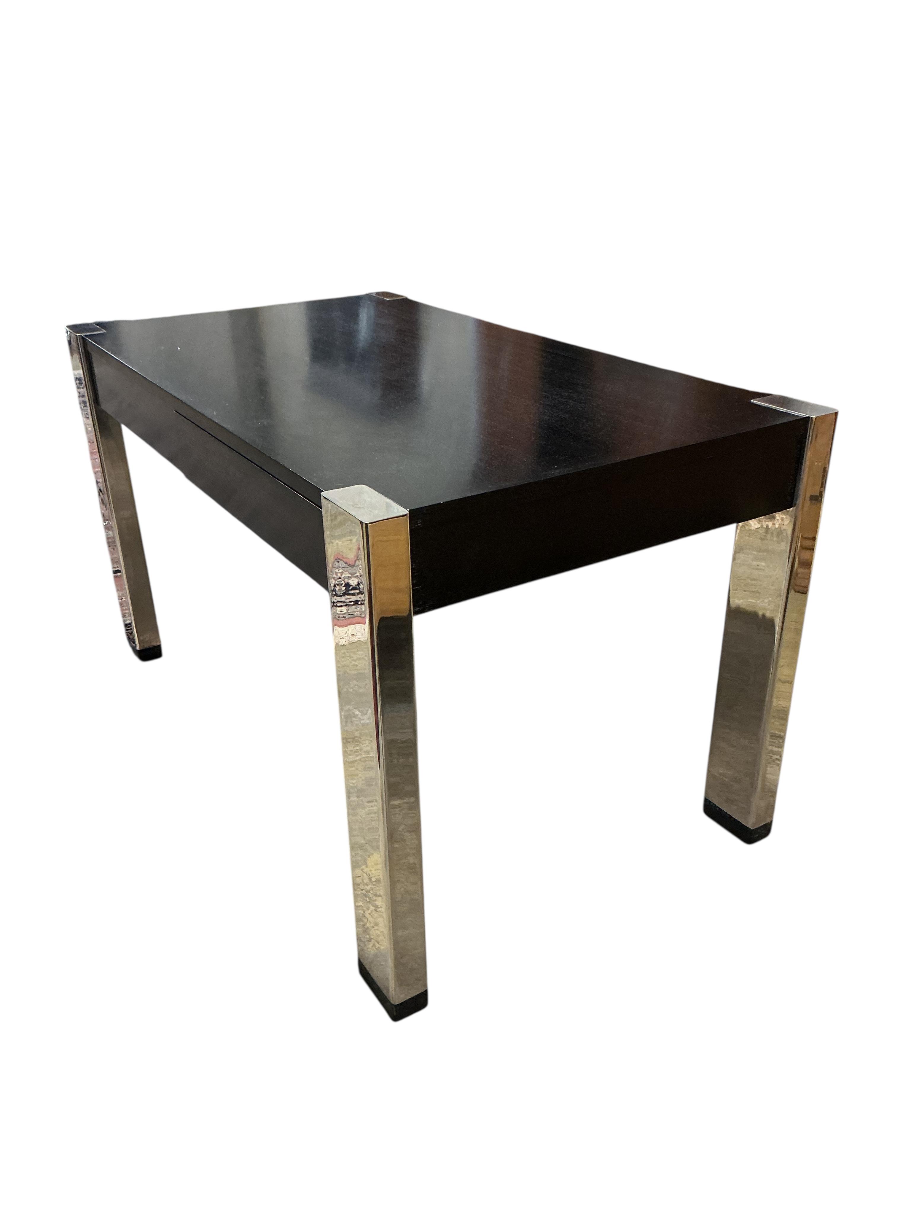 A Contemporary ebonised and chrome desk, retailed by Harrods, width 139cm, depth 78cm, height 78cm